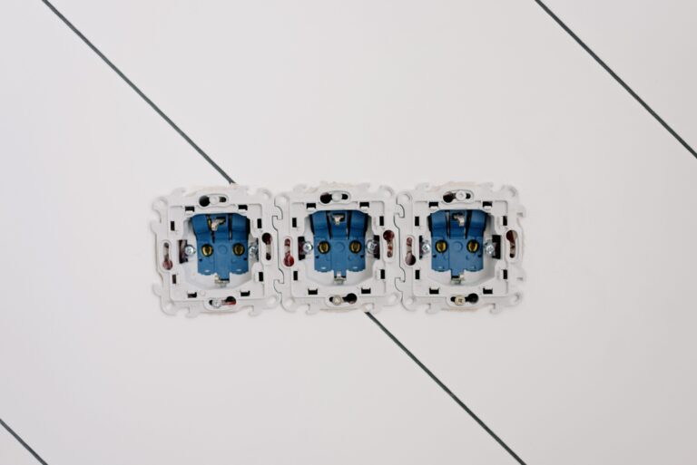 Power sockets with various connectors and bolts on wall in room at home